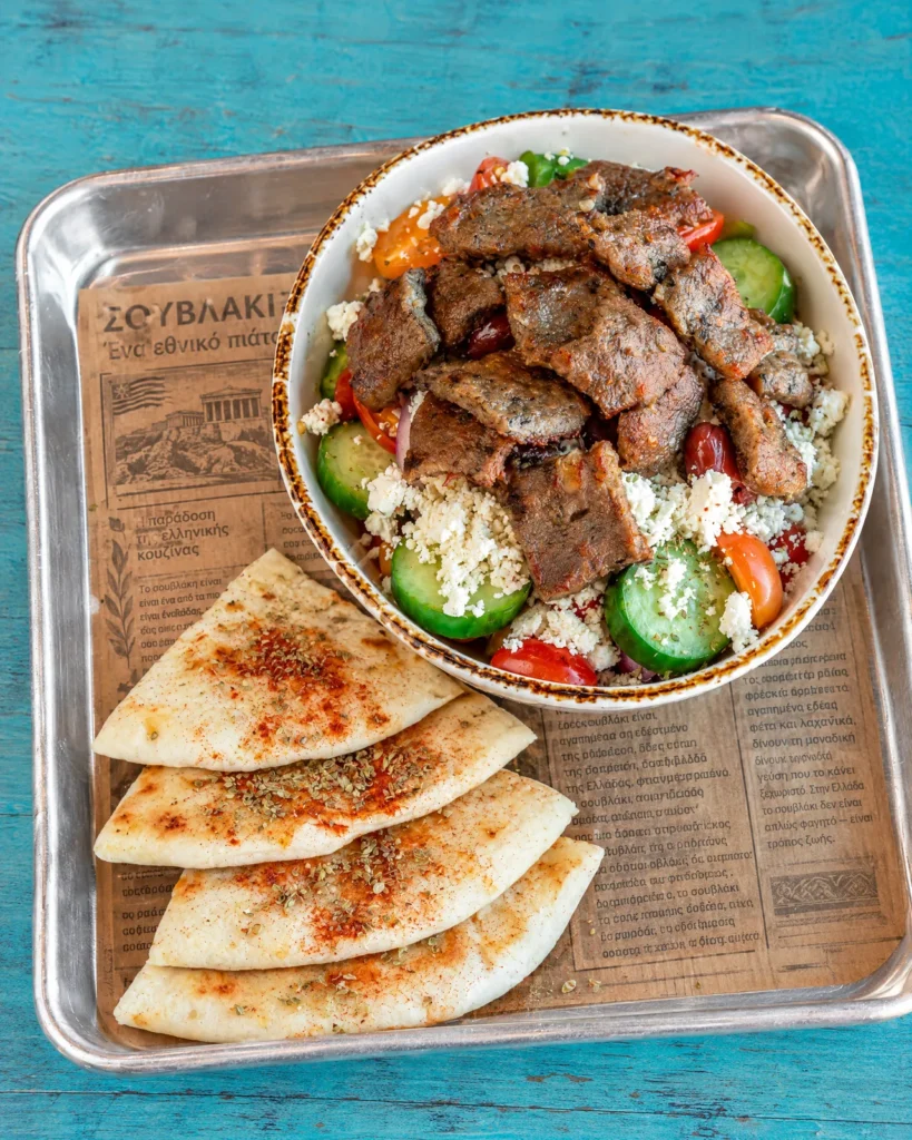 Greek salad bowl topped with gyro